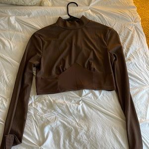 Chocolate brown cropped turtle neck with sheer bottom.